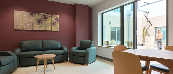 Patient day room showing access to a private courtyard with a sculpture of swifts in flight at the centre