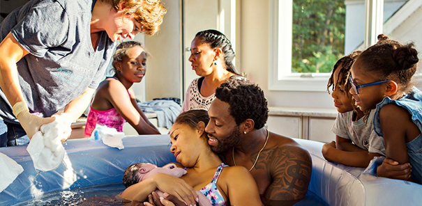 Family together around a birthing pool