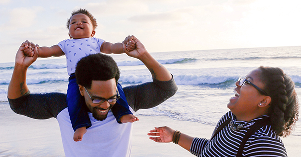 Parents and baby on a beach having fun