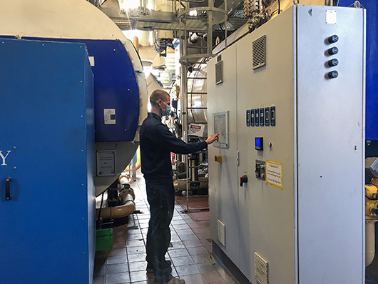 Doug Mackenzie, Engineering Apprentice, at work in the hospital plant room