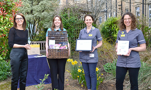 The Dementia Team receiving their Improve Patient Experience Award and gift basket from Chief Executive, Cara Charles-Barks