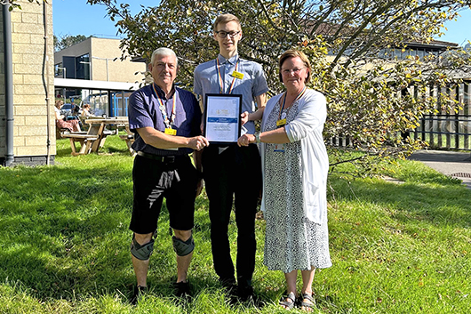 Dominik Kacprzak receiving his certificate of achievement
