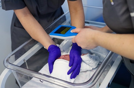 Nurse with baby having a scan