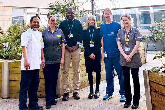 The research team posing for the camera in an RUH courtyard